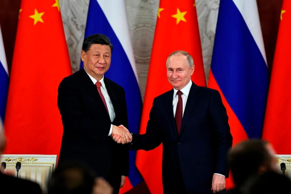 FILE - Russian President Vladimir Putin, right, and Chinese President Xi Jinping shake hands after speaking to the media during a signing ceremony following their talks at The Grand Kremlin Palace, in Moscow, Russia, March 21, 2023. Putin says his regime is prepared to negotiate over the conflict in Ukraine in an interview with Chinese media on the eve of visit to partner Beijing that has backed Moscow in its full-scale invasion of its neighbor. (Mikhail Tereshchenko, Sputnik, Kremlin Pool Photo via AP, File)