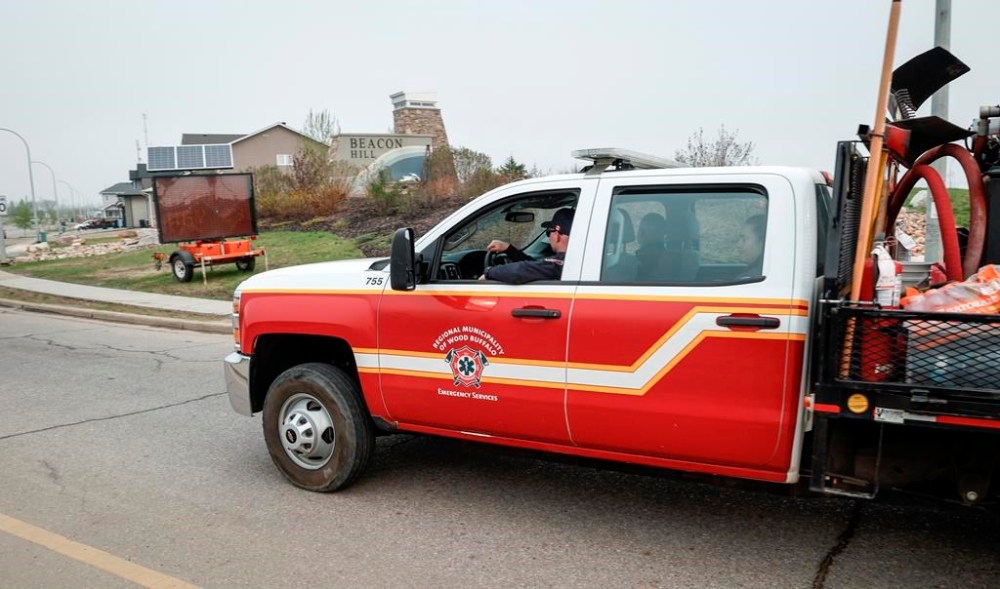 A fire department vehicle enters the evacuated neighbourhood of Beacon Hill in Fort McMurray, Alta., on Wednesday, May 15, 2024. THE CANADIAN PRESS/Jeff McIntosh