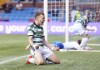 Celtic's Alistair Johnston celebrates after team-mate Daizen Maeda scores their side's second goal of the game during the Scottish Premier League soccer match between Celtic Glasgow and Kilmarnock at The BBSP Stadium Rugby Park, in Kilmarnock, Wednesday May 15, 2024. (Jane Barlow/PA via AP)