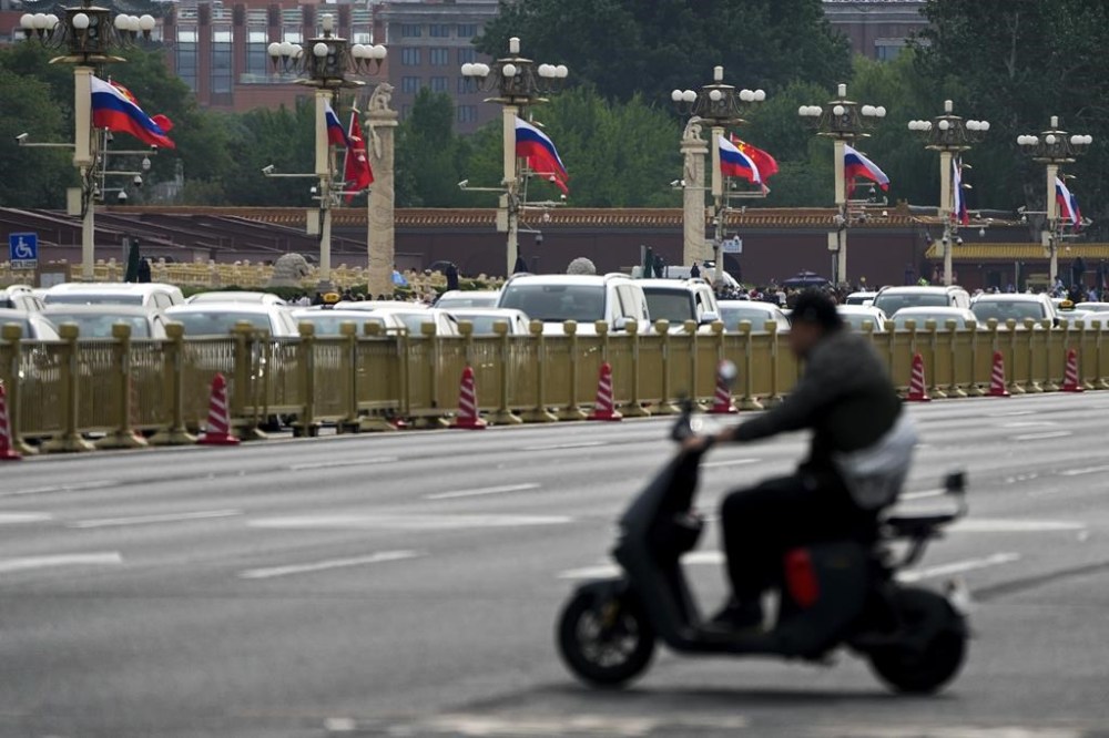 Motorists travel past Russian and Chinese national flags displayed along Tiananmen Gate in honor of Russian President Vladimir Putin's visit, in Beijing, Thursday, May 16, 2024. Putin arrived Thursday in Beijing for a two-day state visit to China, in a show of unity between the authoritarian allies as Moscow presses forward with a new offensive in Ukraine. (AP Photo/Andy Wong)