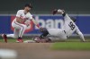 New York Yankees' Aaron Judge (99) beats the tag by Minnesota Twins second baseman Edouard Julien after hitting a double during the second inning of a baseball game Wednesday, May 15, 2024, in Minneapolis. (AP Photo/Abbie Parr)