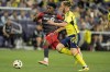 Toronto FC forward Deandre Kerr, left, and Nashville SC defender Walker Zimmerman (25) chase the ball during the first half of an MLS soccer match Wednesday, May 15, 2024, in Nashville, Tenn. THE CANADIAN PRESS/AP-George Walker IV