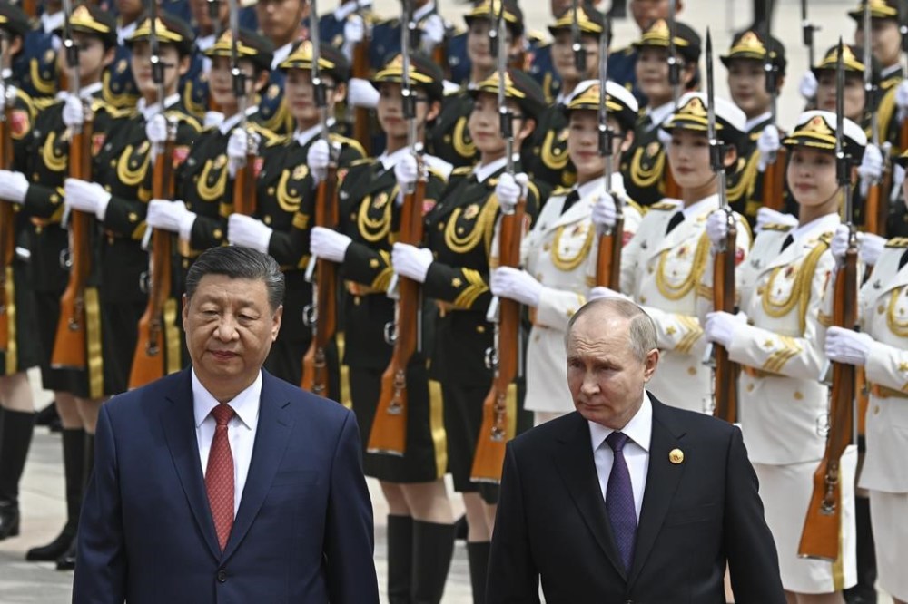 Chinese President Xi Jinpin, left, and Russian President Vladimir Putin review the honor guard during an official welcome ceremony in Beijing, China, Thursday, May 16, 2024. (Sergei Bobylev, Sputnik, Kremlin Pool Photo via AP)