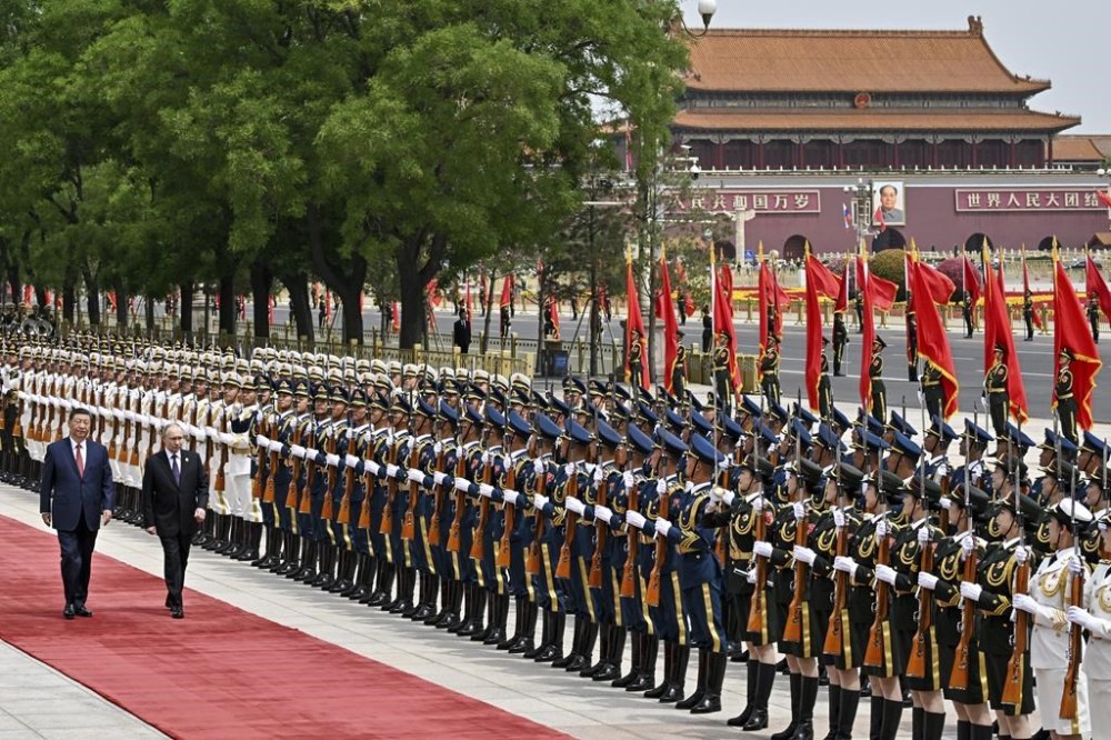 Chinese President Xi Jinping, left, and Russian President Vladimir Putin review the honor guard during an official welcome ceremony in Beijing, China, Thursday, May 16, 2024. (Sergei Bobylev, Sputnik, Kremlin Pool Photo via AP)