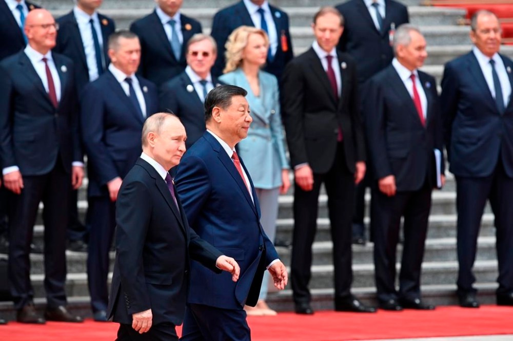 Chinese President Xi Jinping, foreground right, and Russian President Vladimir Putin, foreground left, walk past members of Russian cabinet during an official welcome ceremony in Beijing, China, on Thursday, May 16, 2024. (Sergei Bobylev, Sputnik, Kremlin Pool Photo via AP)