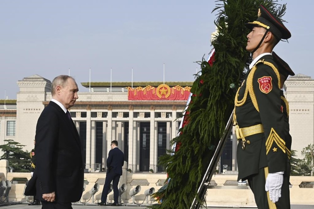 Russian President Vladimir Putin, left, attends a wreath laying ceremony at the Monument to the People's Heroes in Tiananmen Square in Beijing, China, on Thursday, May 16, 2024. (Sergei Bobylev, Sputnik, Kremlin Pool Photo via AP)