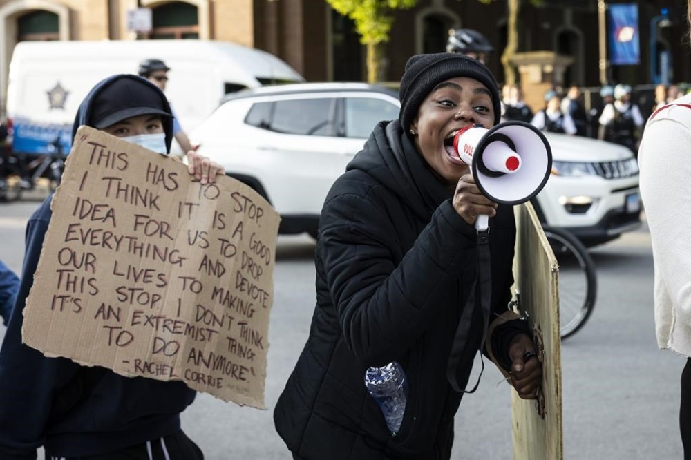 Protesters rally on Fullerton Avenue while crews disassemble the pro-Palestinian encampment in the quad at DePaul University's Lincoln Park campus in Chicago, Thursday, May 16, 2024. (Ashlee Rezin/Chicago Sun-Times via AP)