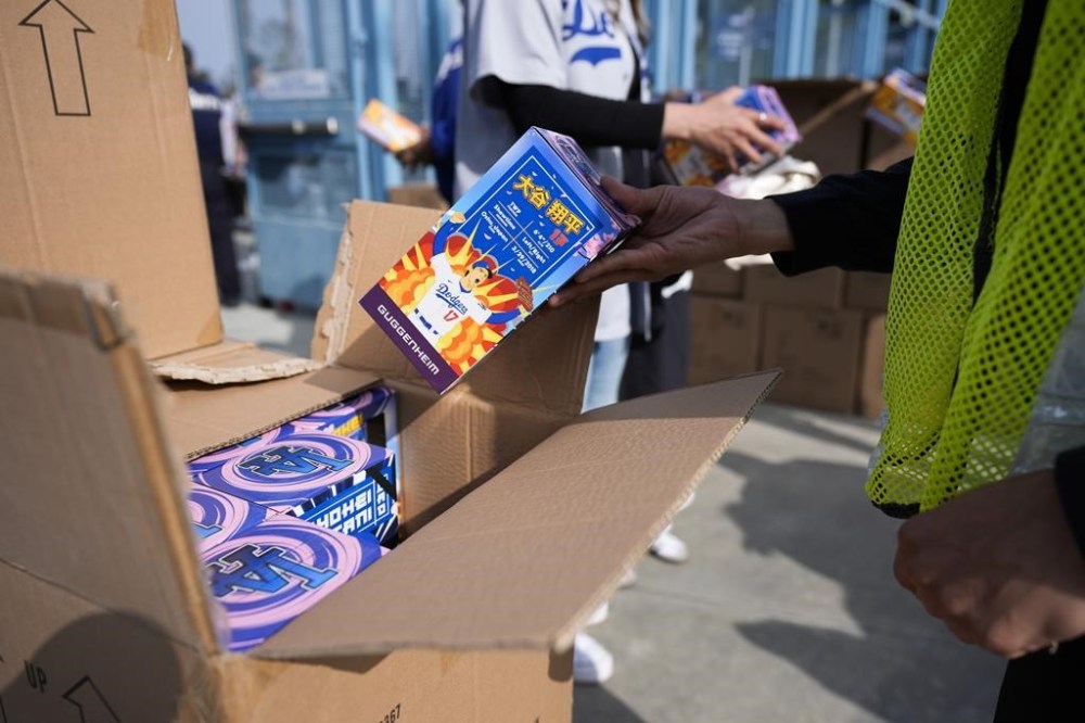 Bobbleheads of Los Angeles Dodgers designated hitter Shohei Ohtani are given to fans before a baseball game against the Cincinnati Reds in Los Angeles, Thursday, May 16, 2024. (AP Photo/Ashley Landis)