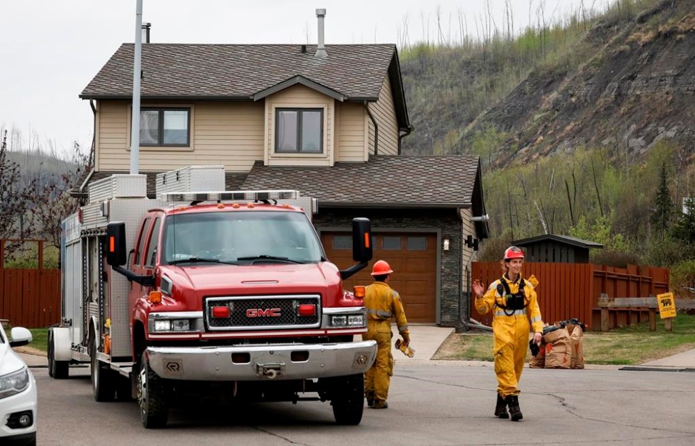 Firefighters patrol the evacuated neighbourhood of Grayling Terrace in Fort McMurray, Alta., Thursday, May 16, 2024.THE CANADIAN PRESS/Jeff McIntosh