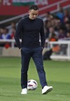 Barcelona's head coach Xavi Hernandez walks on the touchline during a Spanish La Liga soccer match between Barcelona and Real Sociedad at the Olimpic Lluis Companys stadium in Barcelona, Spain, Monday, May 13, 2024. (AP Photo/Joan Monfort)
