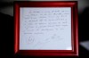 FILE - A framed copy of the napkin linking the 13-year-old Lionel Messi to FC Barcelona is seen in Barcelona, Spain on Jan. 5, 2012. British auction house Bonhams says the famous napkin that linked a young Lionel Messi to Barcelona has sold for $965,000. An agreement in principle to sign then 13-year-old Messi was written on the napkin almost 25 years ago at a Barcelona tennis club. (AP Photo/Manu Fernandez, File)