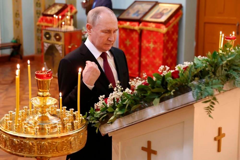 Russian President Vladimir Putin crosses himself as he visits the Church of the Intercession of the Mother of God in Harbin, northeastern China's Heilongjiang Province, on Friday, May 17, 2024. (Alexander Ryumin, Sputnik, Kremlin Pool Photo via AP)
