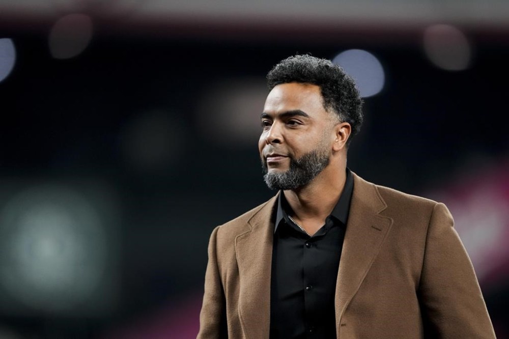 FILE - Former Seattle Mariners player Nelson Cruz looks on after throwing out the ceremonial first pitch before signing a one-day contract to retire with the team before an opening-day baseball game against the Boston Red Sox, Thursday, March 28, 2024, in Seattle. Former outfielder Nelson Cruz was hired by Major League Baseball on Friday, May 17, 2024, as a special adviser for baseball operations. The seven-time All-Star, who turns 44 on July 1, will focus mainly on Latin American topics that include the Dominican Republic and increasing player relations.(AP Photo/Lindsey Wasson, File)