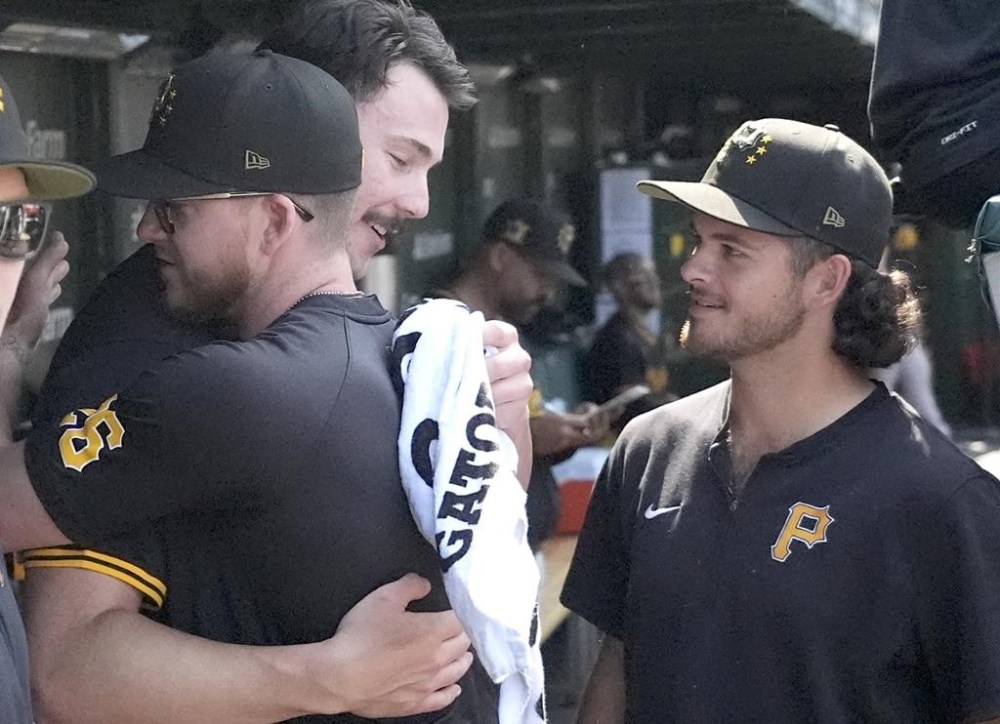 Pittsburgh Pirates' Bailey Falter (26) and Jared Jones, right, congratulate starting pitcher Paul Skenes for pitching six innings of no-hit ball during the seventh inning of a baseball game against the Chicago Cubs, Friday, May 17, 2024, in Chicago. Skenes issued only one walk on 11 strikeouts. (AP Photo/Charles Rex Arbogast)