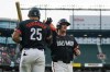 Baltimore Orioles' Adley Rutschman, right, high-fives Anthony Santander (25) after scoring against the Seattle Mariners during the first inning of a baseball game Friday, May 17, 2024, in Baltimore. (AP Photo/Jess Rapfogel)