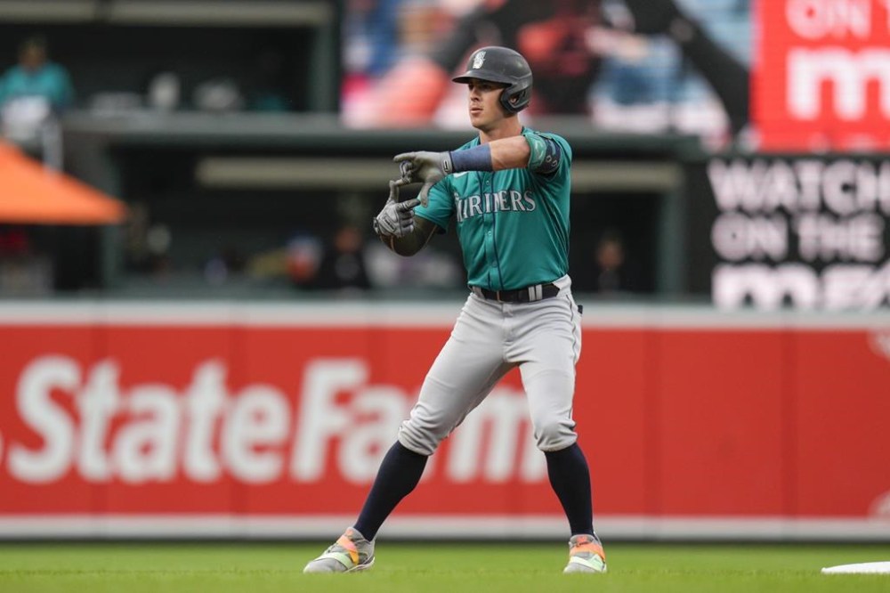 Seattle Mariners' Dylan Moore gestures after hitting a double against the Baltimore Orioles during the first inning of a baseball game Friday, May 17, 2024, in Baltimore. (AP Photo/Jess Rapfogel)