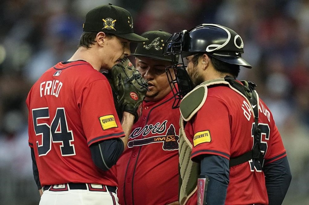 Atlanta Braves' Max Fried (54) speaks with bullpen coach Erick Abreu, center, and catcher Travis d'Arnaud (16) on the mound in the third inning of a baseball game against the San Diego Padres, Friday, May 17, 2024, in Atlanta. (AP Photo/Mike Stewart)