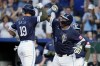 Kansas City Royals' Michael Massey (19) celebrates with Salvador Perez (13) after hitting a two-run home run during the sixth inning of a baseball game against the Oakland Athletics Friday, May 17, 2024, in Kansas City, Mo. (AP Photo/Charlie Riedel)