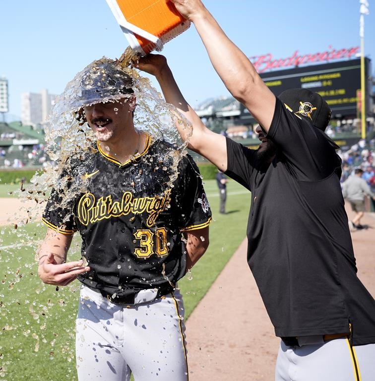 Pittsburgh Pirates starting pitcher Paul Skenes is doused by Martín Pérez during a television interview after the team's win over the Chicago Cubs in a baseball game Friday, May 17, 2024, in Chicago. (AP Photo/Charles Rex Arbogast)