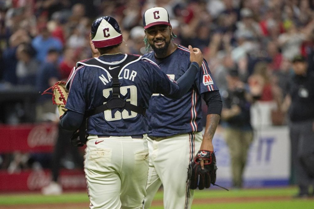 Cleveland Guardians' Bo Naylor, left, congratulates Emmanuel Clase, right, at the end of a baseball game against the Minnesota Twins in Cleveland, Friday, May 17, 2024. (AP Photo/Phil Long)