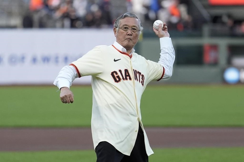 Former San Francisco Giants pitcher Masanori Murakami throws out the ceremonial first pitch before a baseball game between the Giants and the Colorado Rockies in San Francisco, Friday, May 17, 2024. Murakami is the first Japanese player to play in the major leagues. (AP Photo/Jeff Chiu)