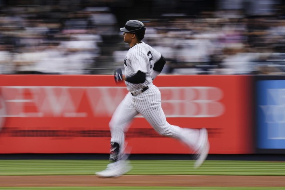 In this image taken with a slow shutter speed, New York Yankees' Juan Soto runs the bases after hitting a home run during the first inning of a baseball game against the Chicago White Sox, Saturday, May 18, 2024, in New York. (AP Photo/Frank Franklin II)