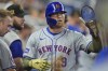 New York Mets' Brandon Nimmo is congratulated by teammates after he scored on a single by Mark Vientos during the first inning of a baseball game against the Miami Marlins, Saturday, May 18, 2024, in Miami. (AP Photo/Wilfredo Lee)