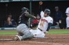 Cleveland Guardians' David Fry, right, scores ahead of the tag by Minnesota Twins' Christian Vazquez during the fifth inning of a baseball game in Cleveland, Saturday, May 18, 2024. (AP Photo/Phil Long)