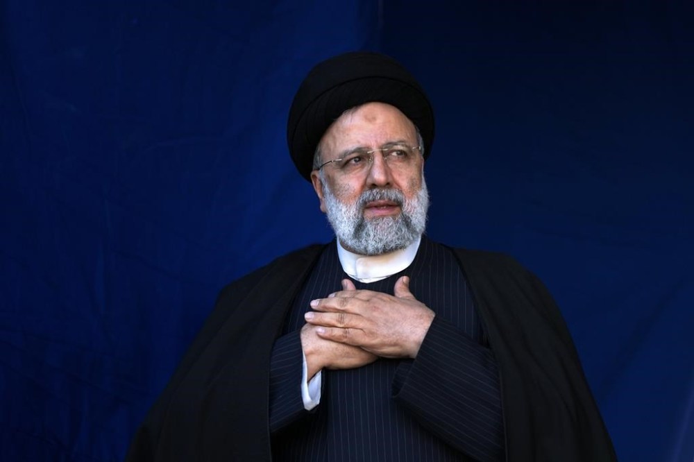 FILE- Iranian President Ebrahim Raisi places his hands on his heart as a gesture of respect to the crowd during the funeral ceremony of the victims of Wednesday's bomb explosion in the city of Kerman about 510 miles (820 kms) southeast of the capital Tehran, Iran, Jan. 5, 2024. A helicopter carrying Iranian President Ebrahim Raisi suffered a “hard landing” on Sunday, May 19, 2024, Iranian state television reported, without immediately elaborating. (AP Photo/Vahid Salemi, File)