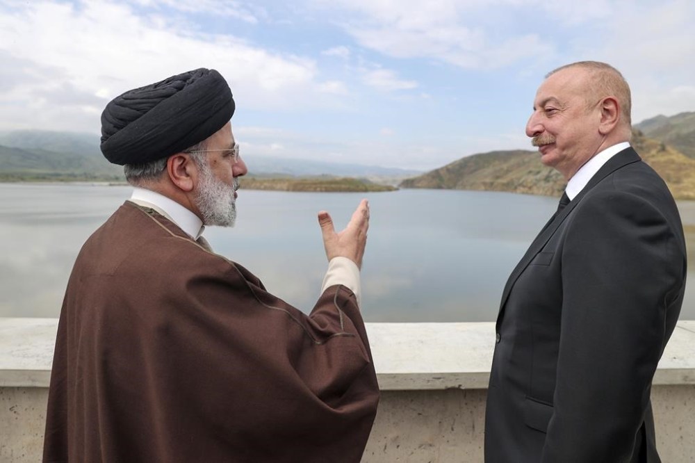 In this photo released by the Iranian Presidency Office, President Ebrahim Raisi, left, speaks with his Azeri counterpart Ilham Aliyev on the inauguration of dam of Qiz Qalasi, or Castel of Girl in Azeri, at the border of Iran and Azerbaijan, Sunday May 19, 2024. A helicopter carrying Iranian President Ebrahim Raisi suffered a
