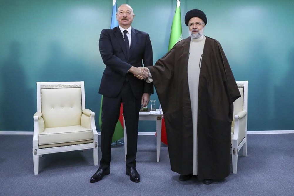 In this photo released by the Iranian Presidency Office, President Ebrahim Raisi, right, shakes hands with his Azeri counterpart Ilham Aliyev during their meeting in the inauguration ceremony of dam of Qiz Qalasi, or Castel of Girl in Azeri, at the border of Iran and Azerbaijan, Sunday, May 19, 2024. A helicopter carrying Iranian President Ebrahim Raisi suffered a