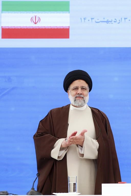 In this photo released by the Iranian Presidency Office, President Ebrahim Raisi clap hands during the inauguration ceremony of dam of Qiz Qalasi, or Castel of Girl in Azeri, at the border of Iran and Azerbaijan with his Azeri counterpart Ilham Aliyev, Sunday, May 19, 2024. A helicopter carrying Iranian President Ebrahim Raisi suffered a