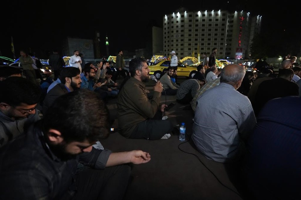 People pray for President Ebrahim Raisi in a ceremony at Vali-e-Asr square in downtown Tehran, Iran, Sunday, May 19, 2024. A helicopter carrying President Raisi, the country's foreign minister and other officials apparently crashed in the mountainous northwest reaches of Iran on Sunday, sparking a massive rescue operation in a fog-shrouded forest as the public was urged to pray. (AP Photo/Vahid Salemi)