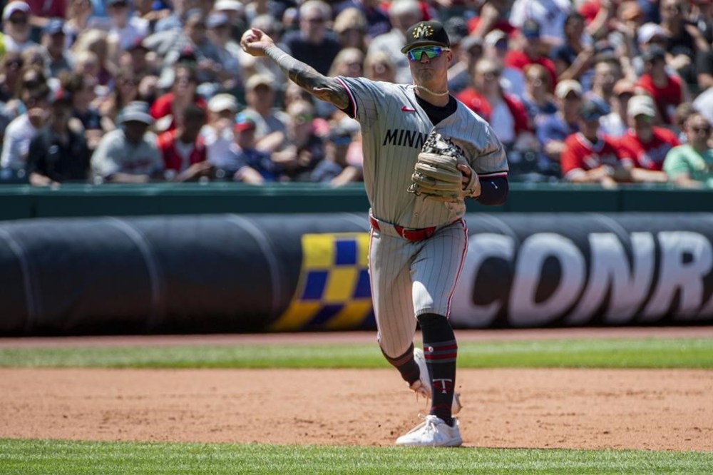 Minnesota Twins' Jose Miranda throws out Cleveland Guardians' Austin Hedges during the fifth inning of a baseball game in Cleveland, Sunday, May 19, 2024. (AP Photo/Phil Long)