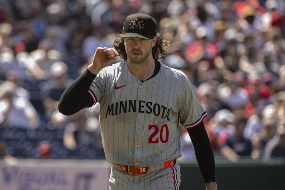 Minnesota Twins starting pitcher Chris Paddack walks to the dugout at the end of the seventh inning of a baseball game against the Cleveland Guardians in Cleveland, Sunday, May 19, 2024. (AP Photo/Phil Long)