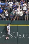 Los Angeles Angels outfielder Jo Adell jumps at the wall as a home run by Texas Rangers' Corey Seager gets to fans in the stands during the fourth inning of a baseball game in Arlington, Texas, Sunday, May 19, 2024. (AP Photo/LM Otero)
