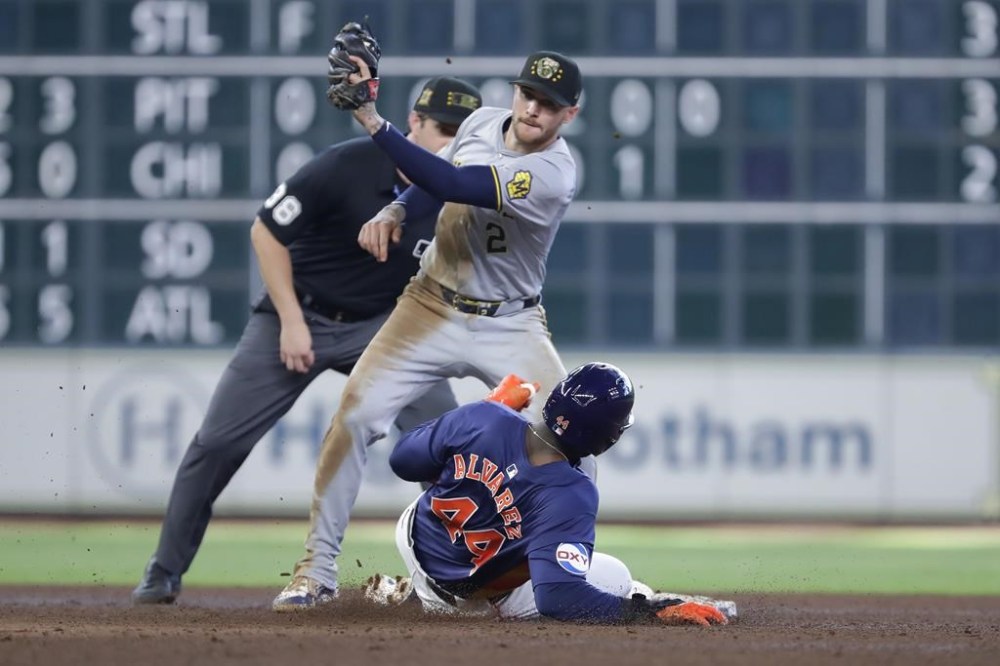 Milwaukee Brewers second baseman Brice Turang (2) is late with the tag as Houston Astros designated hitter Yordan Alvarez (44) safely steals second base during the seventh inning of a baseball game, Sunday, May 19, 2024, in Houston. (AP Photo/Michael Wyke)