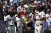 San Francisco Giants' Heliot Ramos, right, celebrates next to Colorado Rockies catcher Jacob Stallings, left, after hitting a solo home run during the sixth inning of a baseball game Sunday, May 19, 2024, in San Francisco. (AP Photo/Godofredo A. Vásquez)