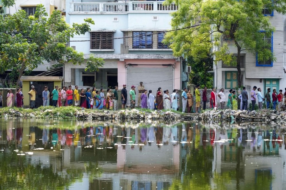 People queue up to vote outside a polling booth during the fifth round of multi-phase national election in Howrah, India, Monday, May 20, 2024. (AP Photo/Bikas Das)