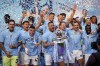 FILE - Manchester City's Kyle Walker celebrates with the Premier League trophy after the English Premier League soccer match between Manchester City and West Ham United at the Etihad Stadium in Manchester, England, Sunday, May 19, 2024. A fourth-straight Premier League title for Manchester City marks an unprecedented period of dominance by one team in English soccer. (AP Photo/Dave Thompson, File)