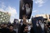 People hold up posters of Iranian President Ebrahim Raisi during a mourning ceremony for him at Vali-e-Asr square in downtown Tehran, Iran, Monday, May 20, 2024. President Raisi and the country's foreign minister were found dead Monday hours after their helicopter crashed in fog, leaving the Islamic Republic without two key leaders as extraordinary tensions grip the wider Middle East. (AP Photo/Vahid Salemi)