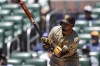 San Diego Padres' Luis Arraez (4) hits a single against the Atlanta Braves in the first inning of a baseball game, Monday, May 20, 2024, in Atlanta. (AP Photo/Mike Stewart)