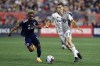 Toronto FC's Jordan Perruzza (77) and New England Revolution's Latif Blessing (19) compete during the second half of an MLS soccer match, in Foxborough, Mass., Saturday, June 24, 2023. THE CANADIAN PRESS/AP-Michael Dwyer