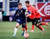 Vancouver Whitecaps FC midfielder Ryan Gauld, left, controls the ball as Cavalry FC midfielder Charlie Trafford chases him during second half soccer action in the Canadian Championship quarterfinal, leg 1, in Calgary, Tuesday, May 7, 2024. THE CANADIAN PRESS/Jeff McIntosh