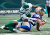 Winnipeg Blue Bombers receiver Drew Wolitarsky (82) is tackled by Saskatchewan Roughriders defenders during the first half of preseason CFL football action in Regina, Monday, May 20, 2024. THE CANADIAN PRESS/Heywood Yu