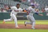 Cleveland Guardians third base José Ramírez, left, tags out New York Mets' J.D. Martinez, right, between second and third base in the second inning of a baseball game Monday, May 20, 2024, in Cleveland. (AP Photo/Sue Ogrocki)