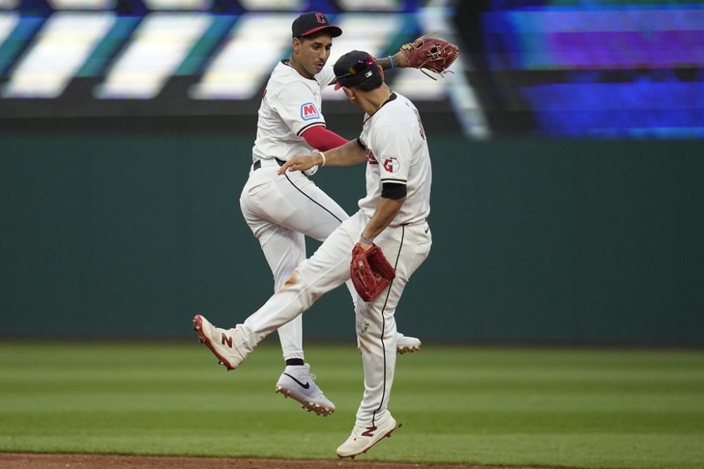 Cleveland Guardians shortstop Brayan Rocchio, left, and Andrés Giménez celebrate after the Guardians defeated the Mets in a baseball game Monday, May 20, 2024, in Cleveland. (AP Photo/Sue Ogrocki)