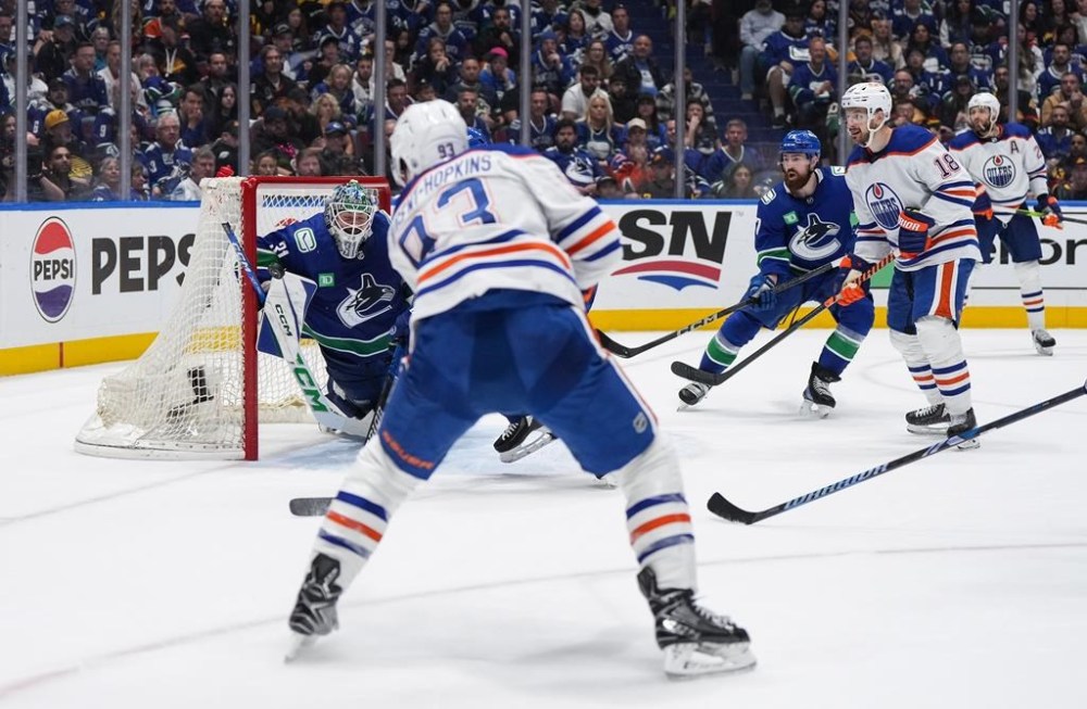 Edmonton Oilers' Ryan Nugent-Hopkins, front left, scores against Vancouver Canucks goalie Arturs Silovs (31) as Filip Hronek (17) and Edmonton's Zach Hyman (18) and Leon Draisaitl (29) watch during the second period in Game 7 of an NHL hockey Stanley Cup second-round playoff series, in Vancouver, on Monday, May 20, 2024. THE CANADIAN PRESS/Darryl Dyck