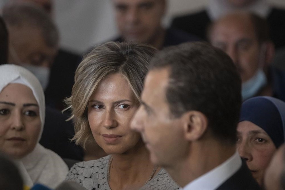 FILE - Syria's first lady Asma Assad, second left, listens to her husband Syrian President Bashar Assad as he speaks to the media after they voted at a polling station during the Presidential elections in the town of Douma, in the eastern Ghouta region, near the Syrian capital Damascus, Syria, on May 26, 2021. Syrian first lady Asma Assad has been diagnosed with leukemia, the office of President Bashar Assad announced Tuesday, May 21, 2024. (AP Photo/Hassan Ammar, File)