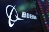 The logo for Boeing appears on a screen above a trading post on the floor of the New York Stock Exchange, July 13, 2021. Boeing Co. is expanding its sizeable footprint in Canada, becoming the anchor tenant of a new innovation zone in the Montreal area. THE CANADIAN PRESS/AP/Richard Drew